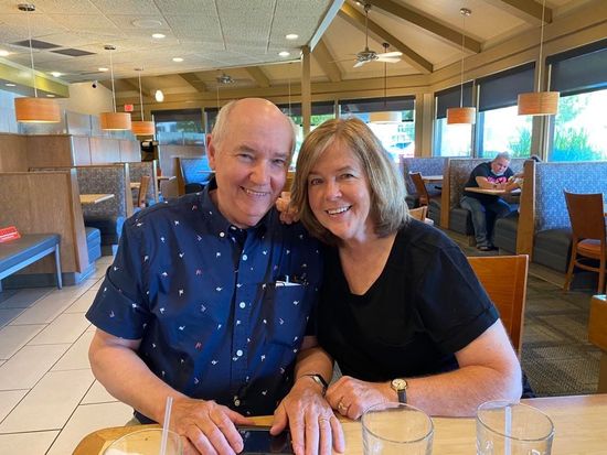 A man and a woman are sitting at a table in a restaurant.