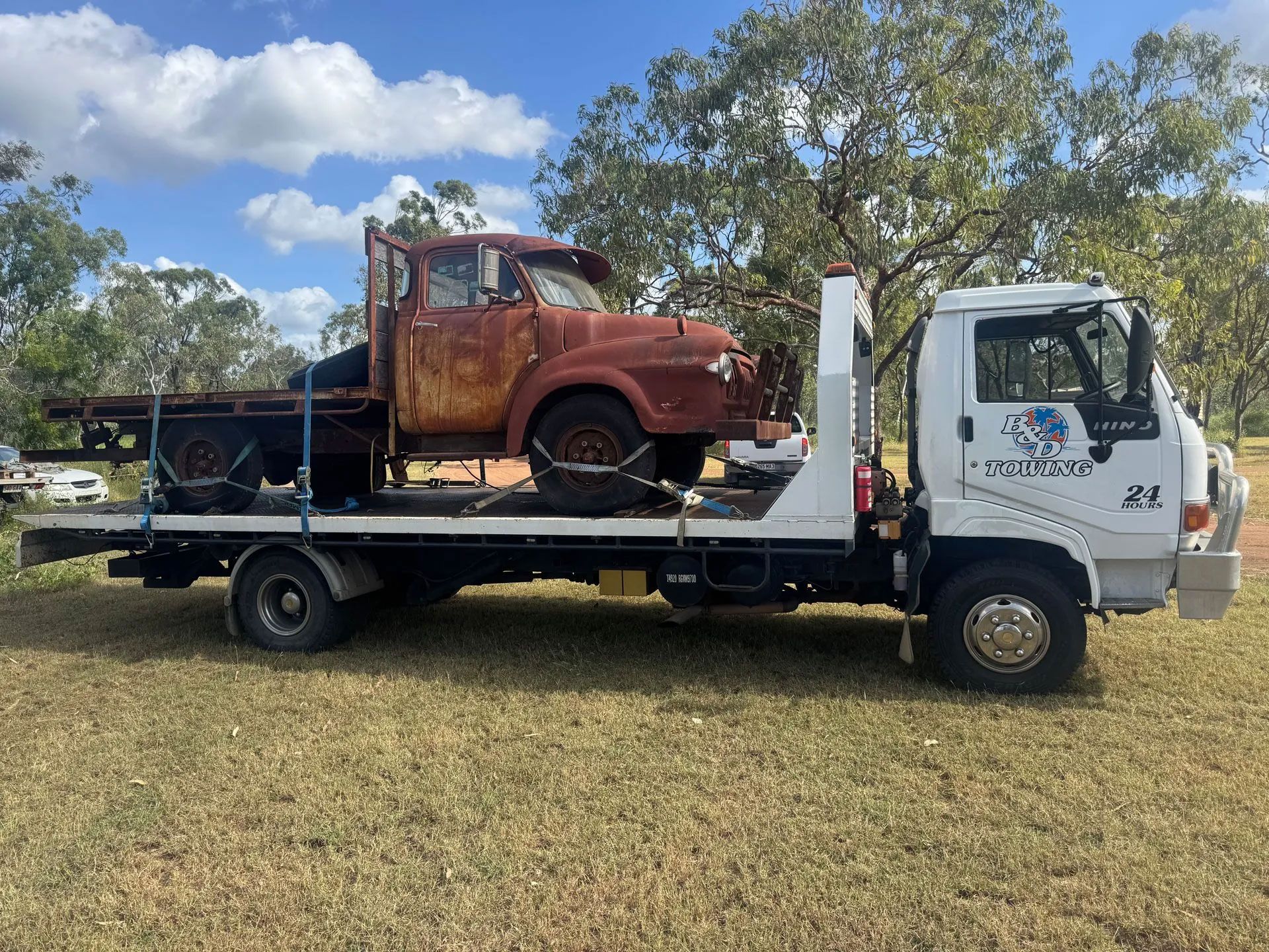 A Rusty Vintage Truck Loaded Onto a Flatbed Tow Truck — B&D Auto Group & Towing in Bowen, QLD