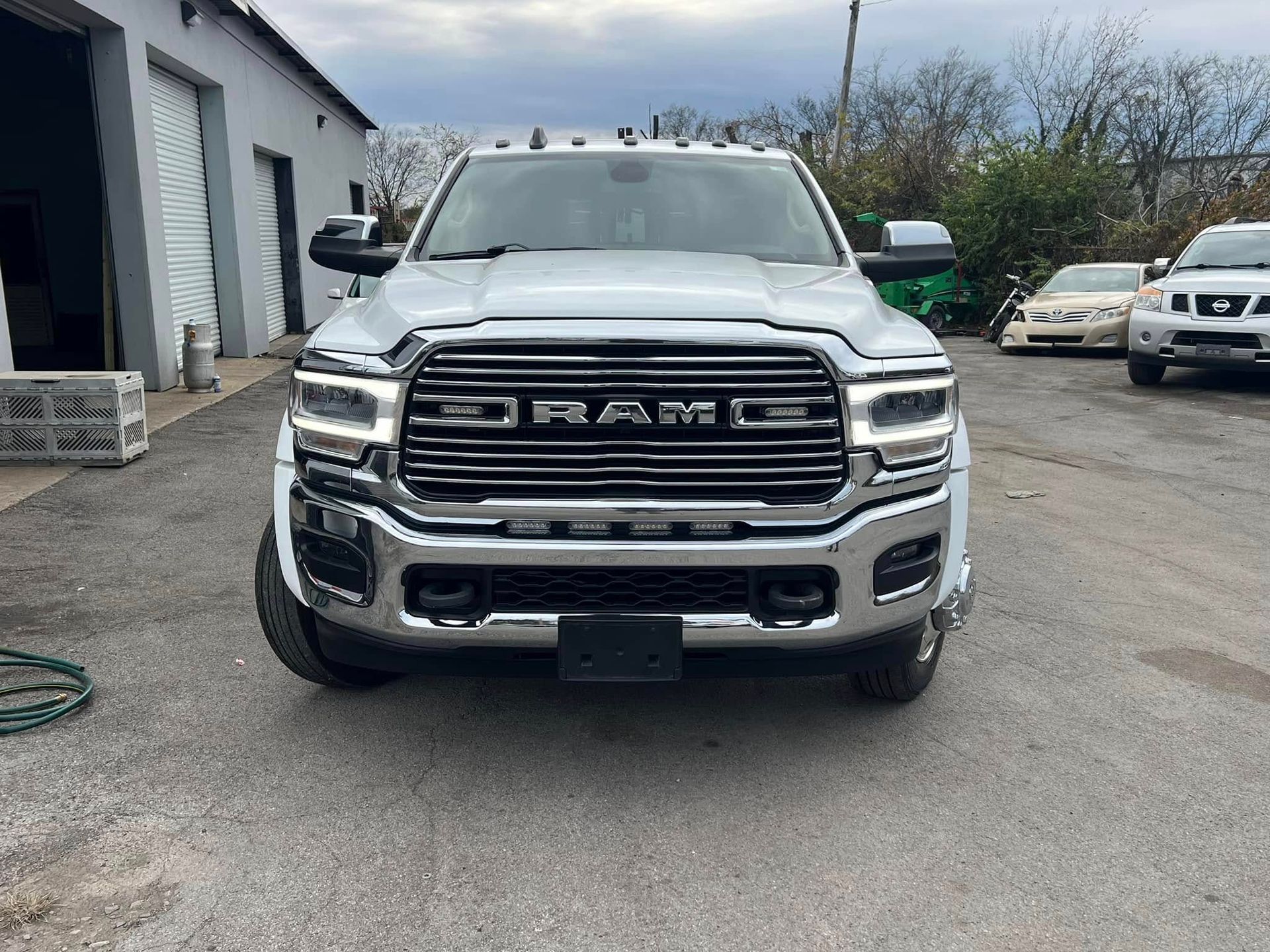 Front view of a silver RAM pickup truck parked outside a building.