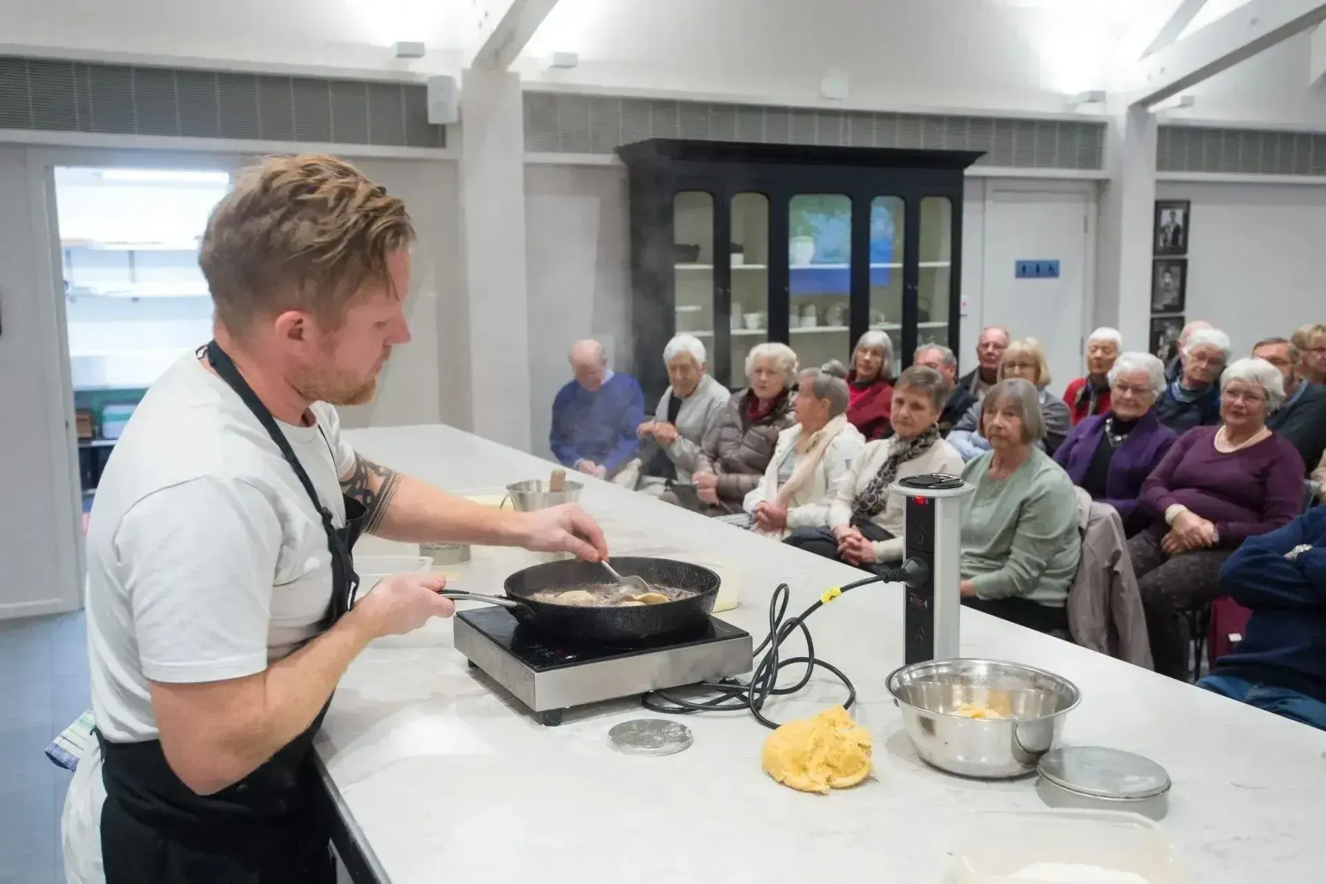 Chef teaching cooking class to village residents