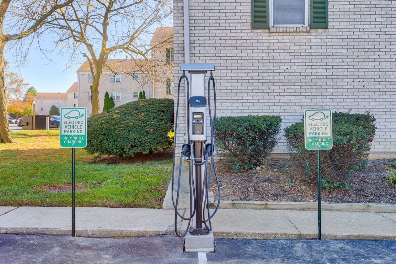 OBrookbend Apartments on-site EV charging station in the property's exterior area, with signs indicating electric vehicle parking only.