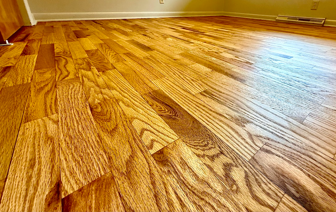 A close up of a wooden floor in a room.