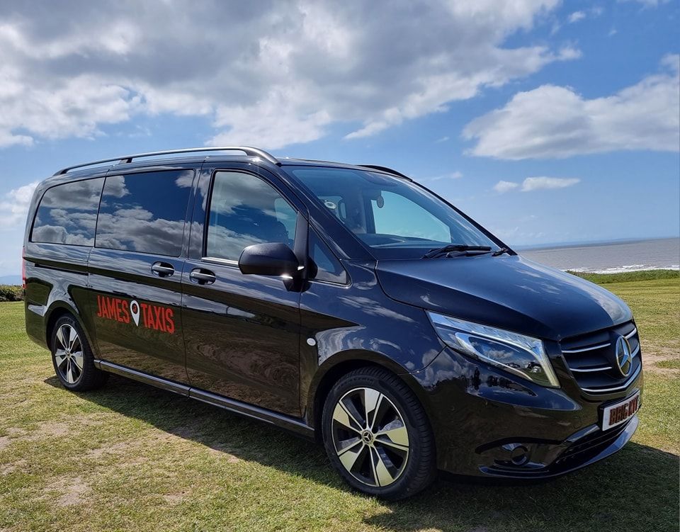 side view of the black taxi