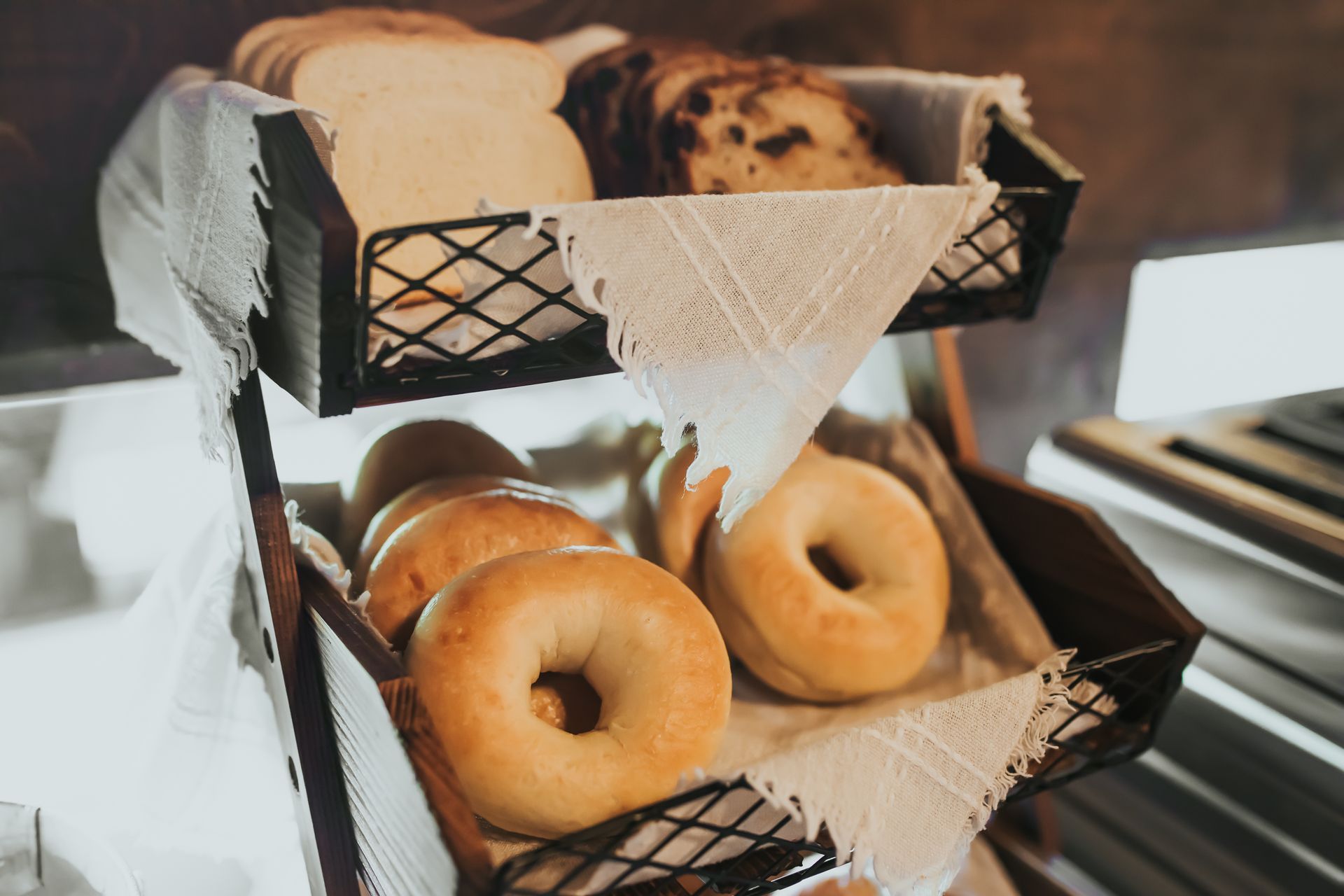 Bread baskets with bagels and sliced bread.