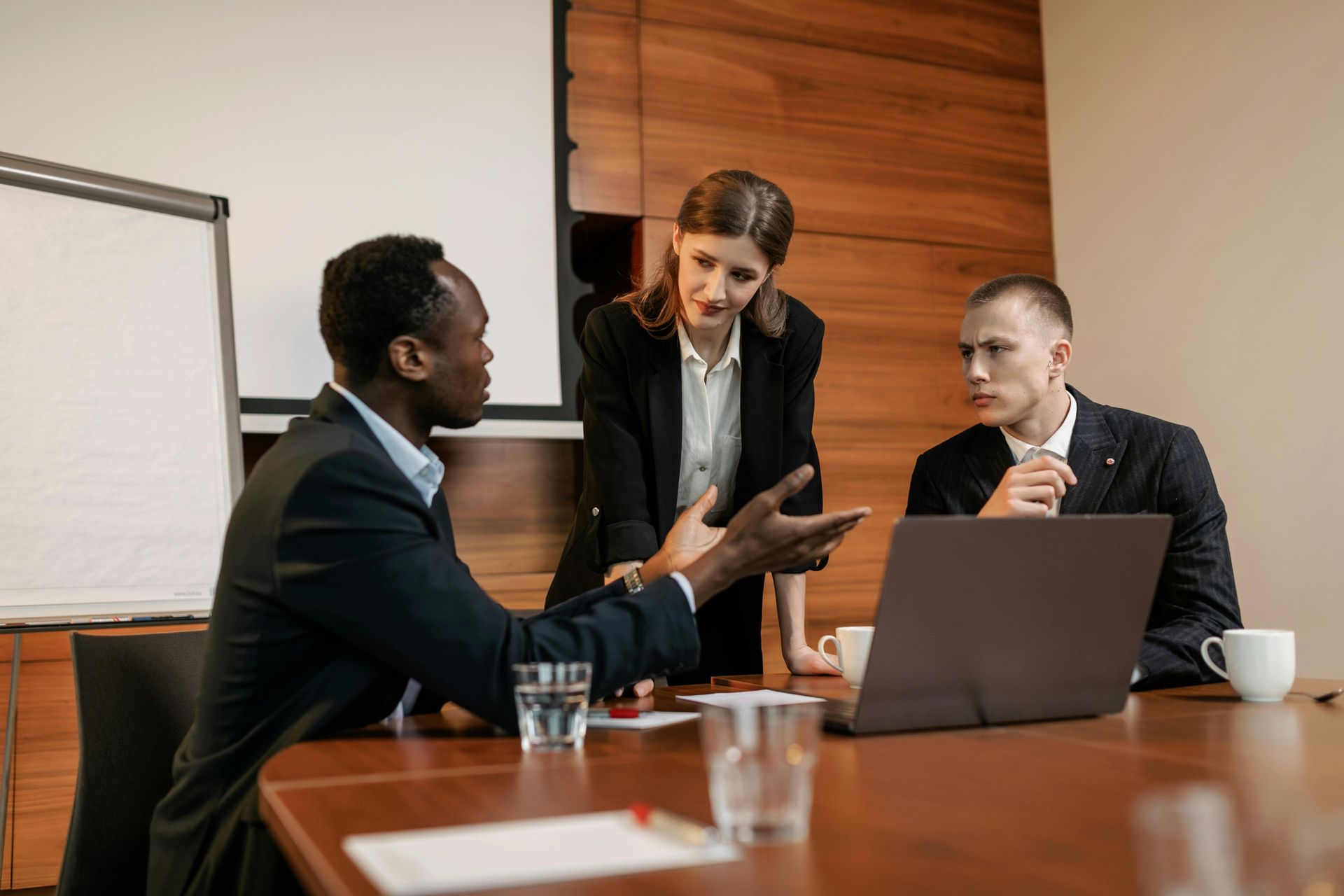A group of business people are having a meeting in a conference room.