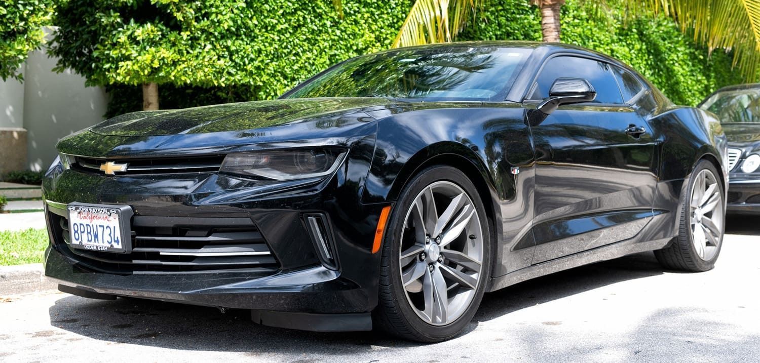 Black Chevrolet Camaro parked outdoors.