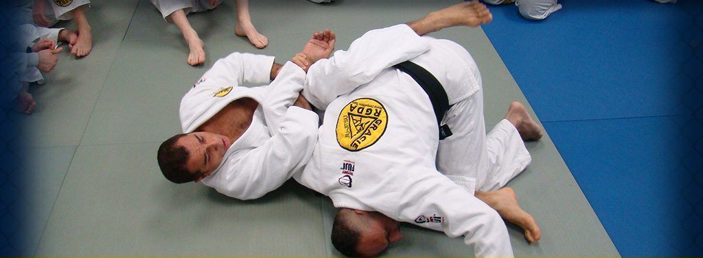 A young boy in a white karate uniform with a blue belt