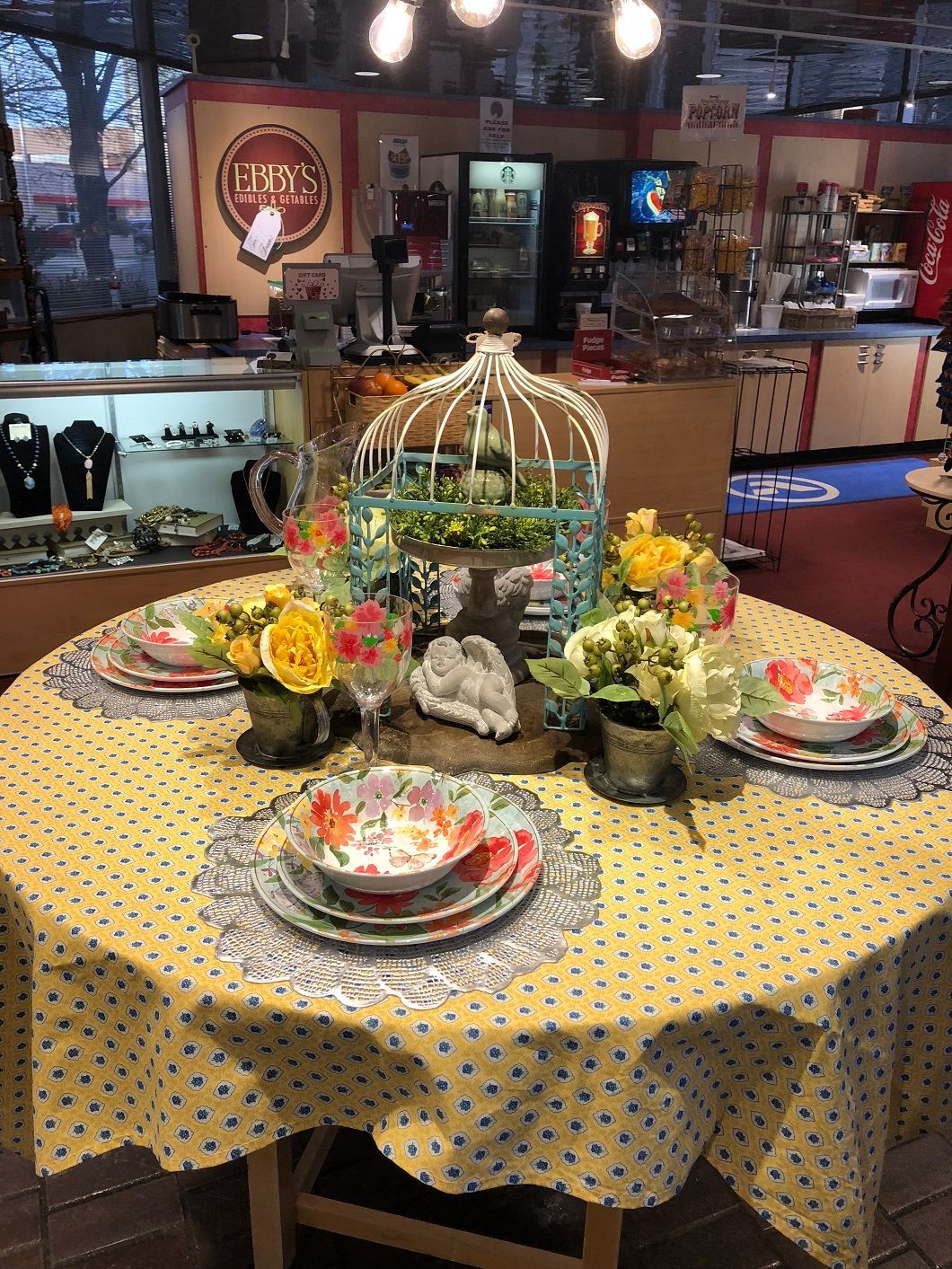 Decorated dining table with floral centerpiece and colorful plates in a restaurant setting