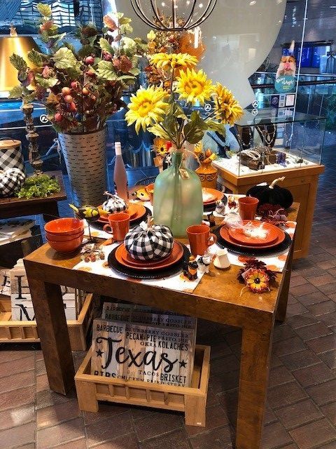 Decorated rustic table with sunflowers, pumpkins, and fall decor, labeled “Texas”