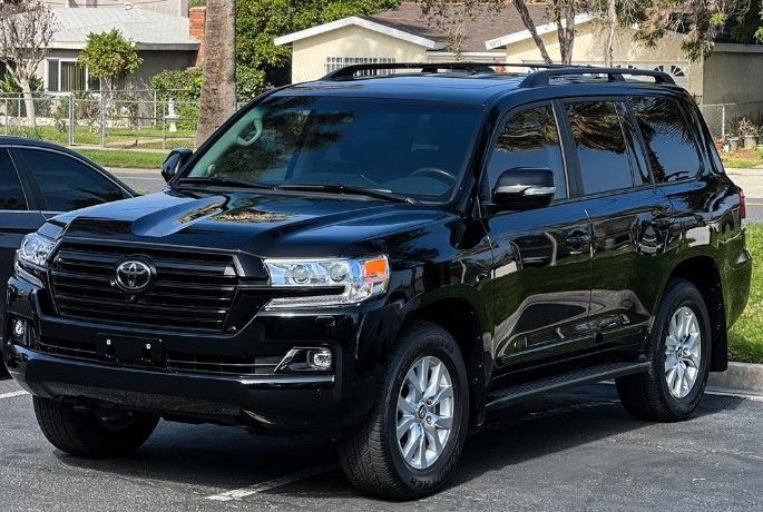 Black Toyota SUV parked on a street in a residential neighborhood
