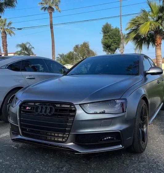A silver audi is parked next to a silver car