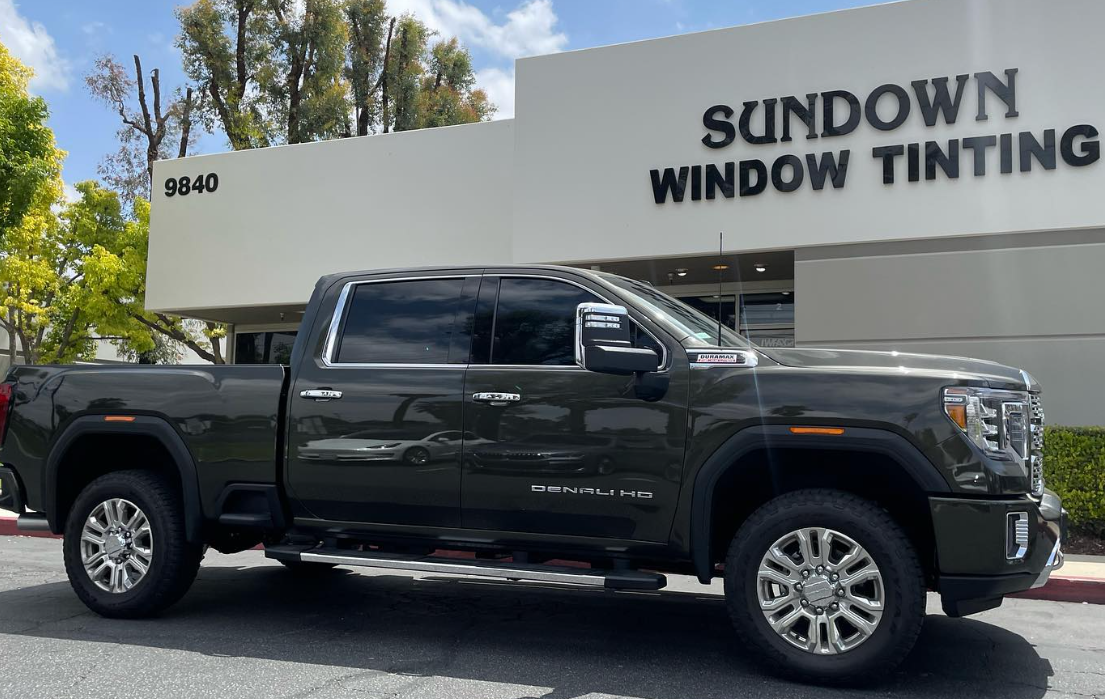 Black pickup truck parked outside Sundown Window Tinting storefront