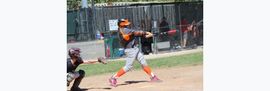 Baseball player sliding into home plate, catcher in front. Blue and gold uniforms, action shot.