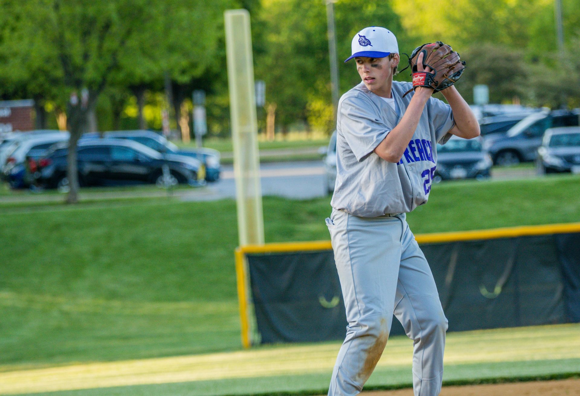 Baseball player sliding into base as another player attempts to catch the ball.