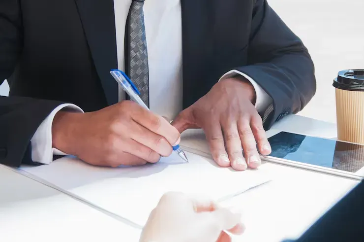 Business man filling out paperwork