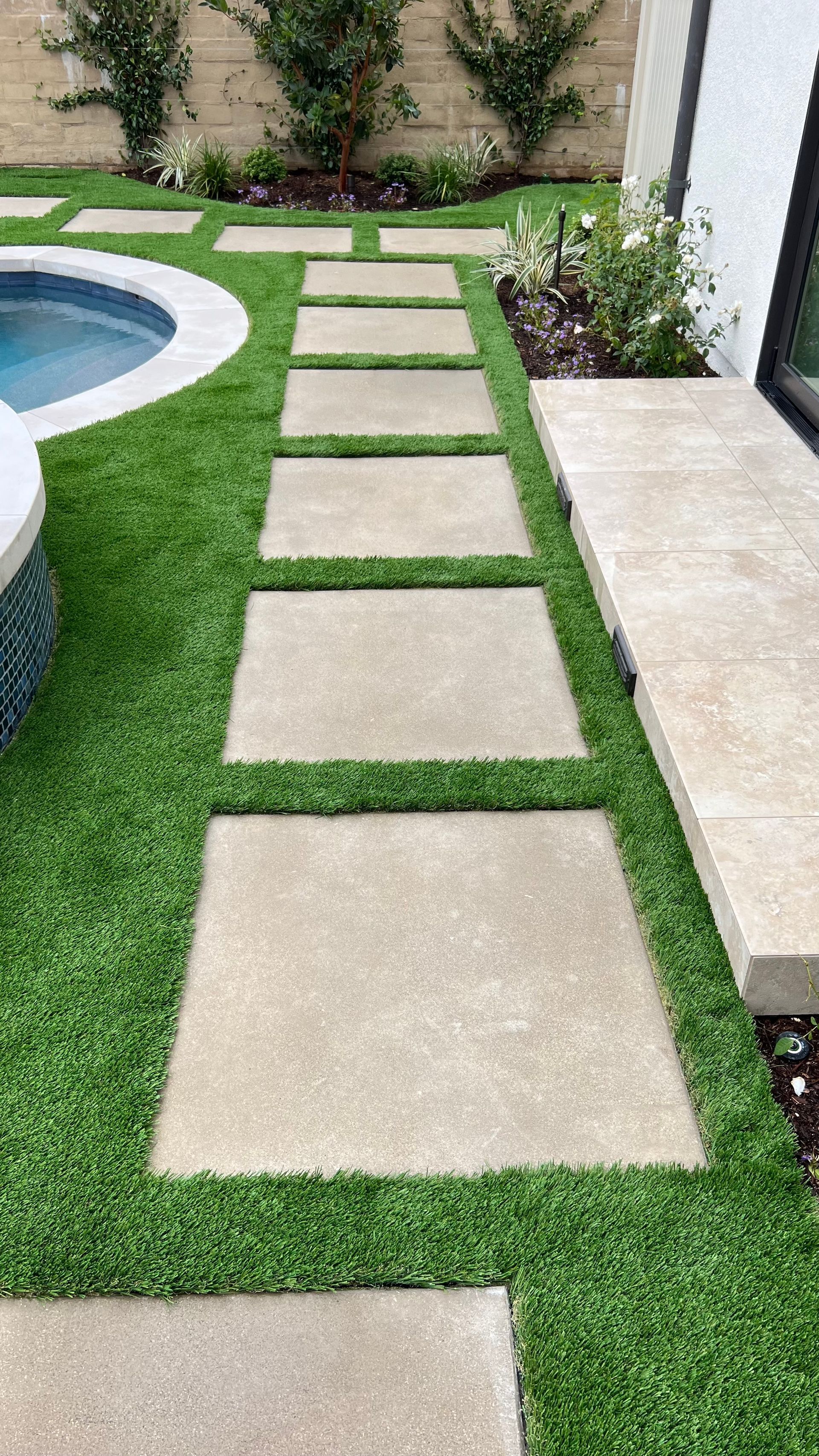 synthetic grass and step stones parkway