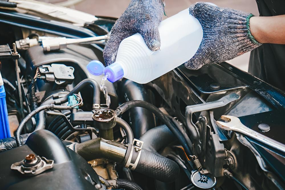 Person is Pouring Water Into a Car Engine — Kirk Auto Know Mechanical in Stuart, QLD