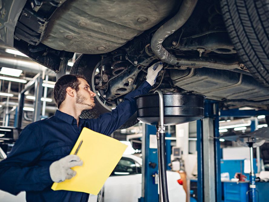 Mechanic Holding A Clipboard Examining The Car — Kirk Auto Know Mechanical in Stuart, QLD