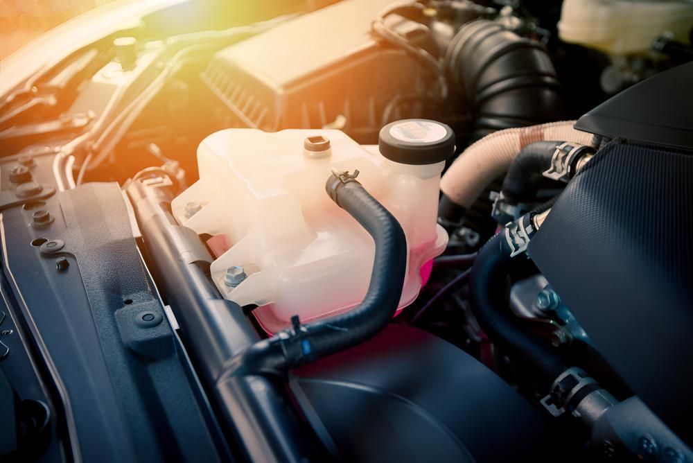 Close Up of the Engine of a Car With a Red Liquid in It — Kirk Auto Know Mechanical in Stuart, QLD