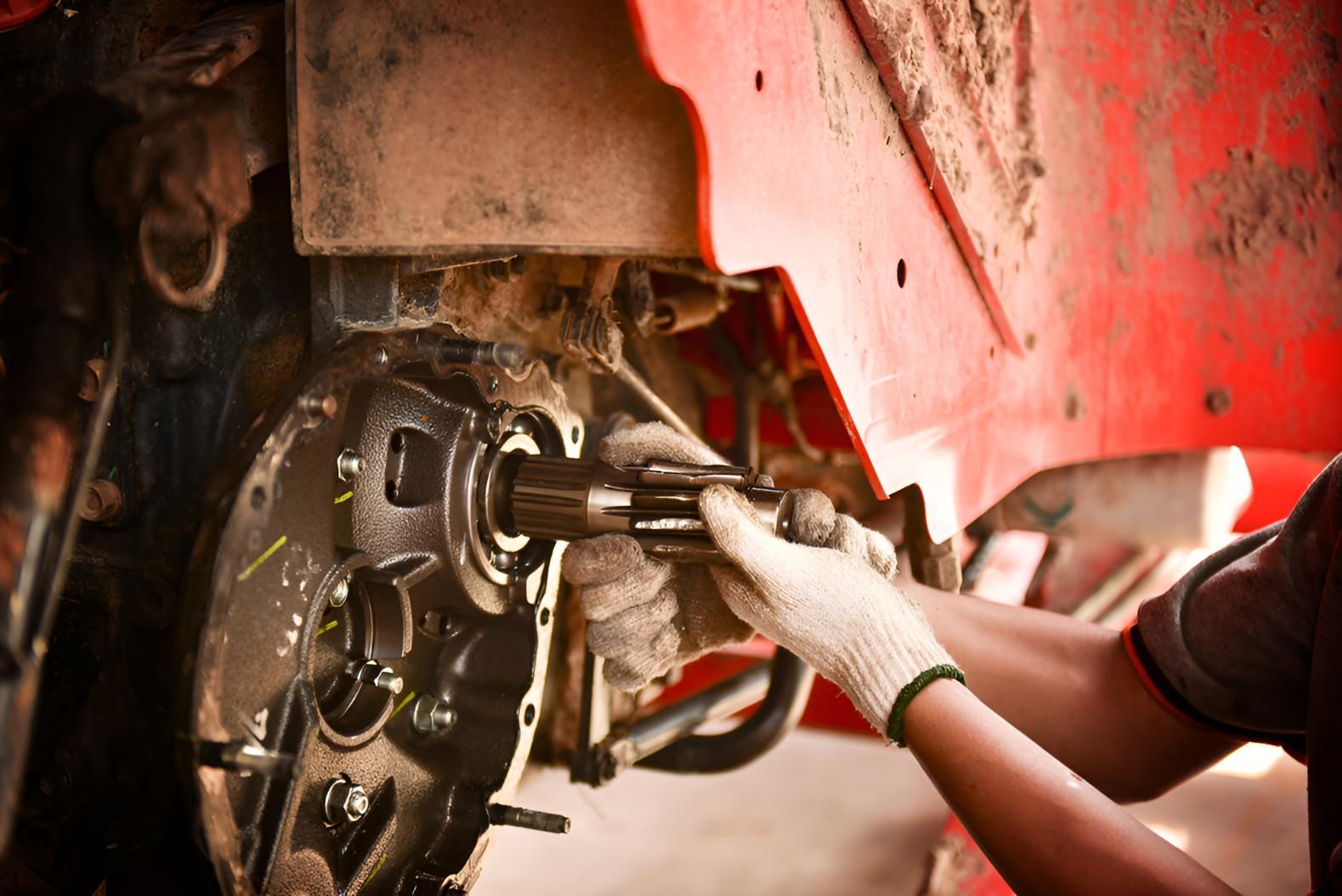 Man is Working on a Red Tractor in a Garage — Kirk Auto Know Mechanical in Stuart, QLD
