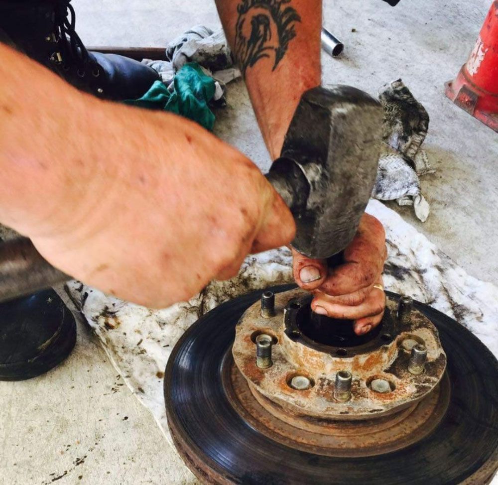 Man Repairing The Drum Brakes — Kirk Auto Know Mechanical in Stuart, QLD