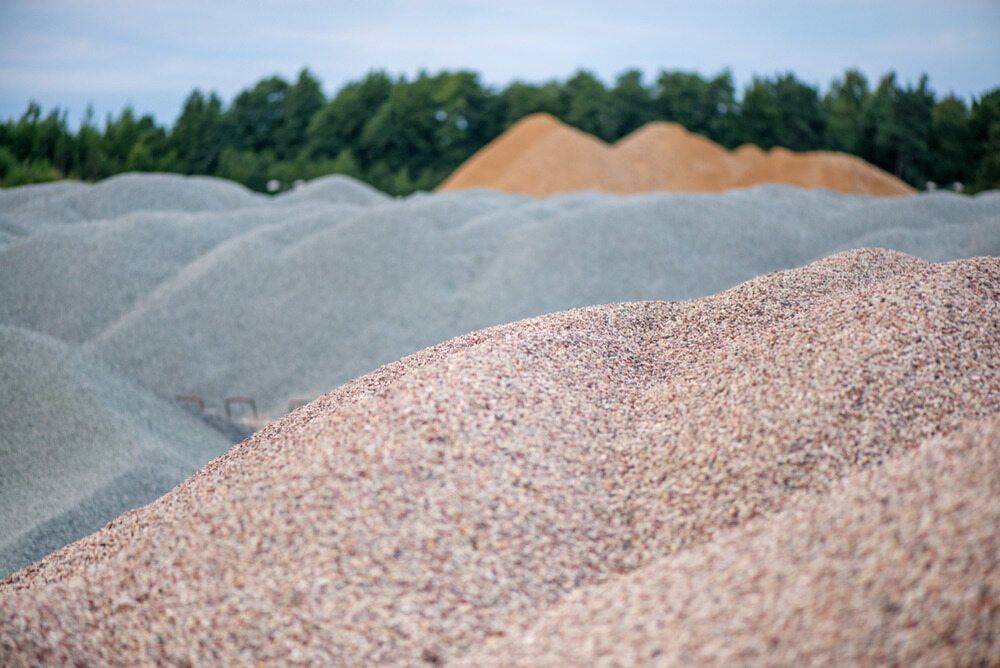 A Pile Of Gravel Is Sitting In A Field With Trees In The Background — Pigot's Mid Western Sand and Soil In Orange, NSW