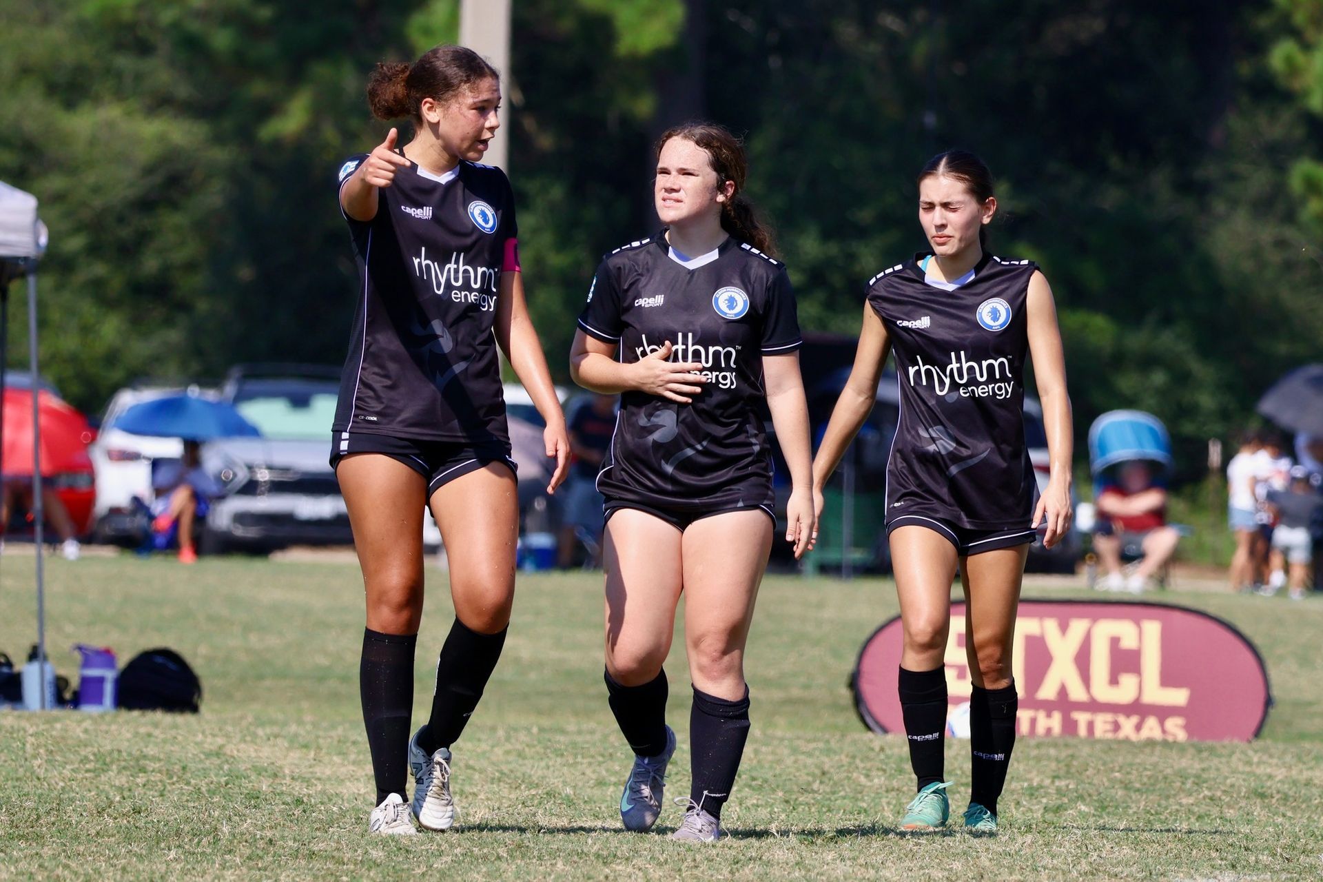 Three soccer players for Albion Hurricanes FC on the field