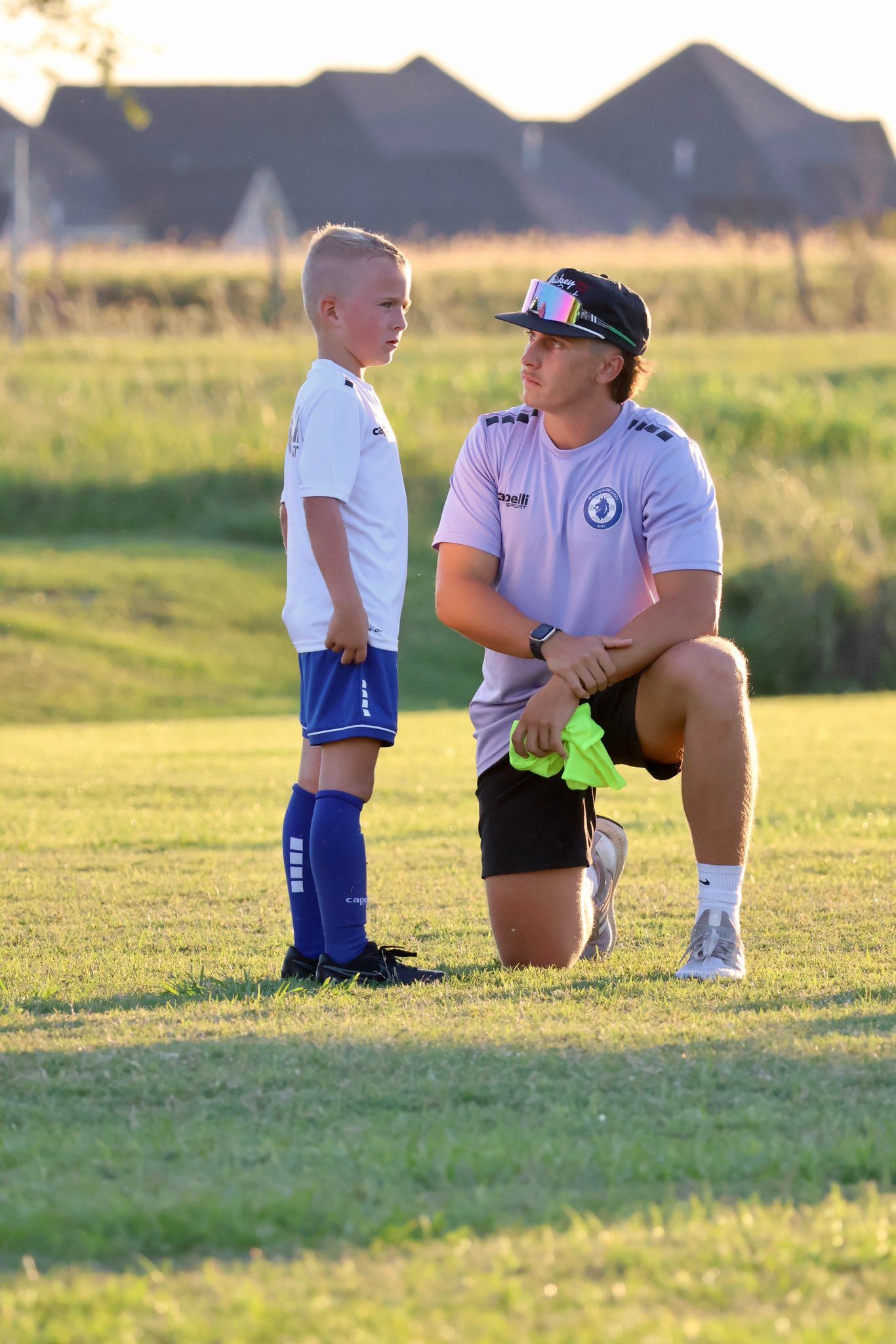 Albion Hurricanes FC coach talking to a young player
