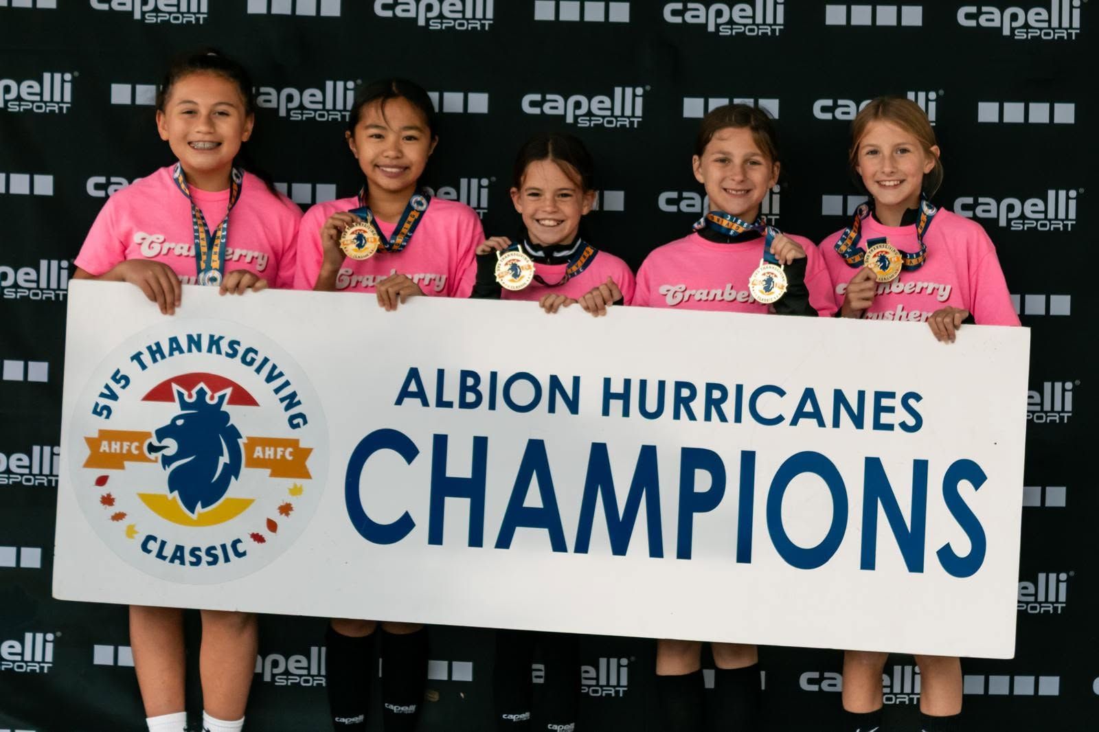 Albion Hurricanes FC team posing together on a field.