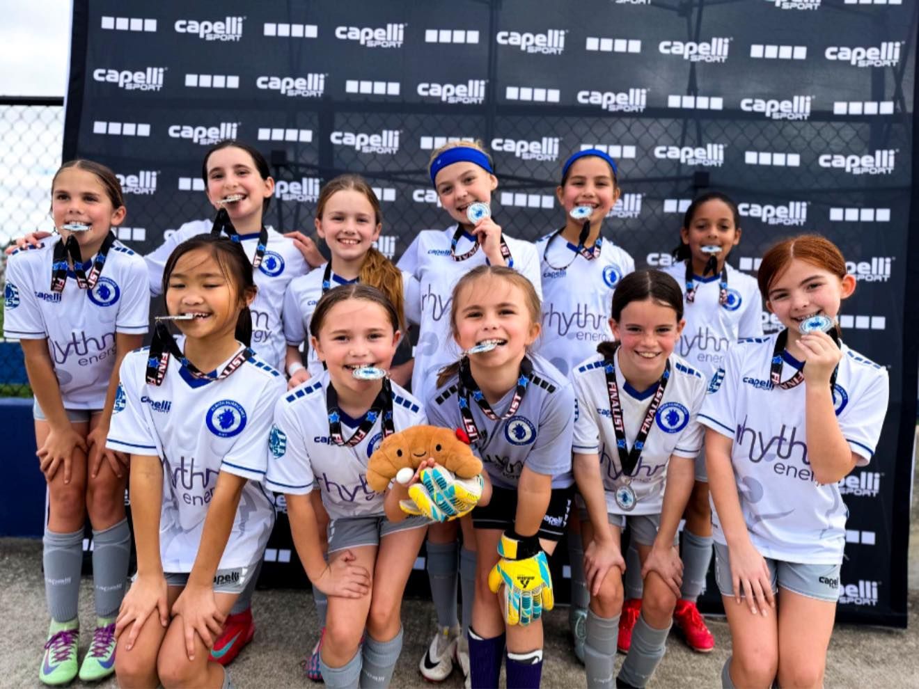 Albion Hurricanes FC team posing with medals