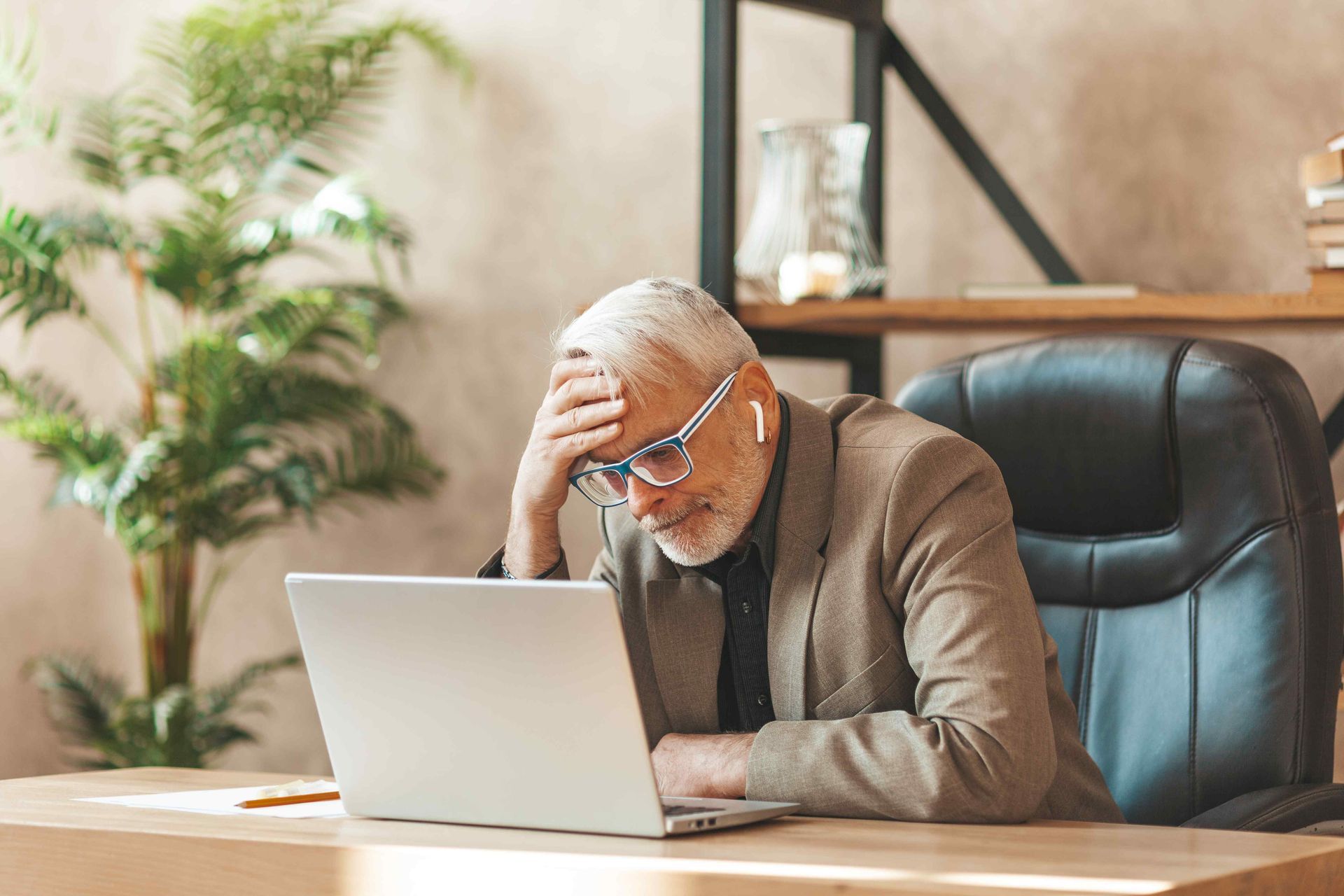 a frustrated business owner looking at his computer 