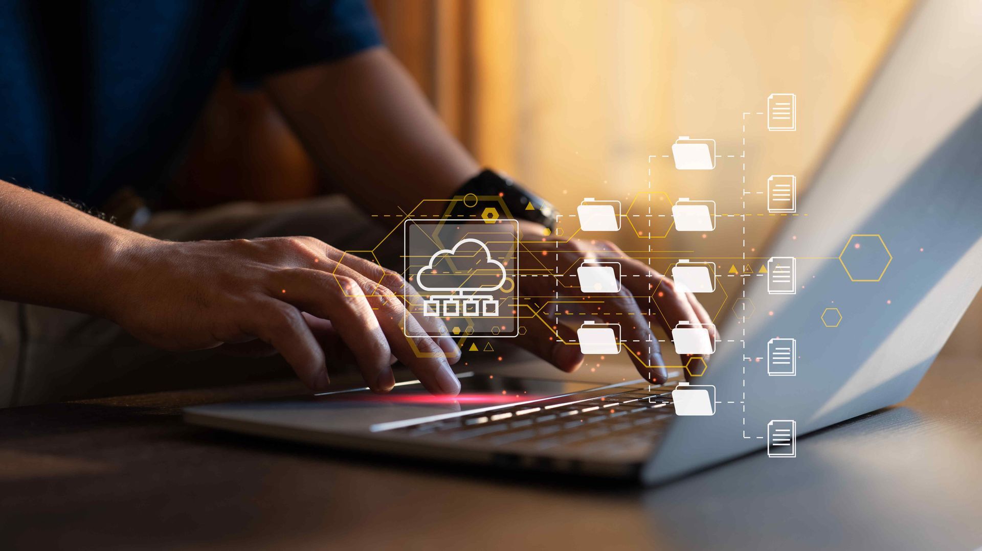 Image of a typing person's hands surrounded by icons of folders and cloud images