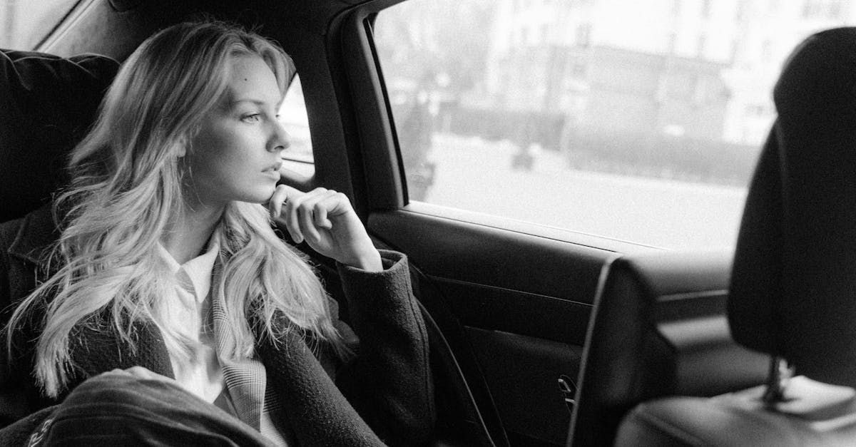 Female business owner looking out of a window, contemplating the value of investing in a website for