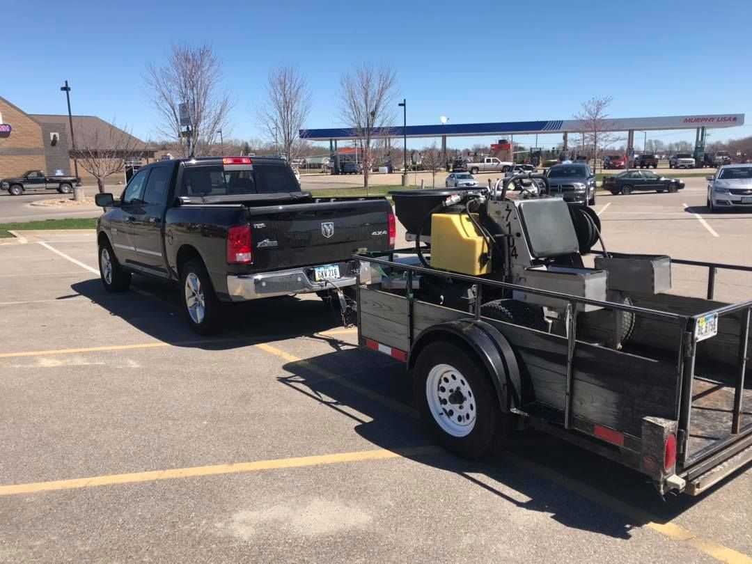 A truck and trailer are parked in a parking lot