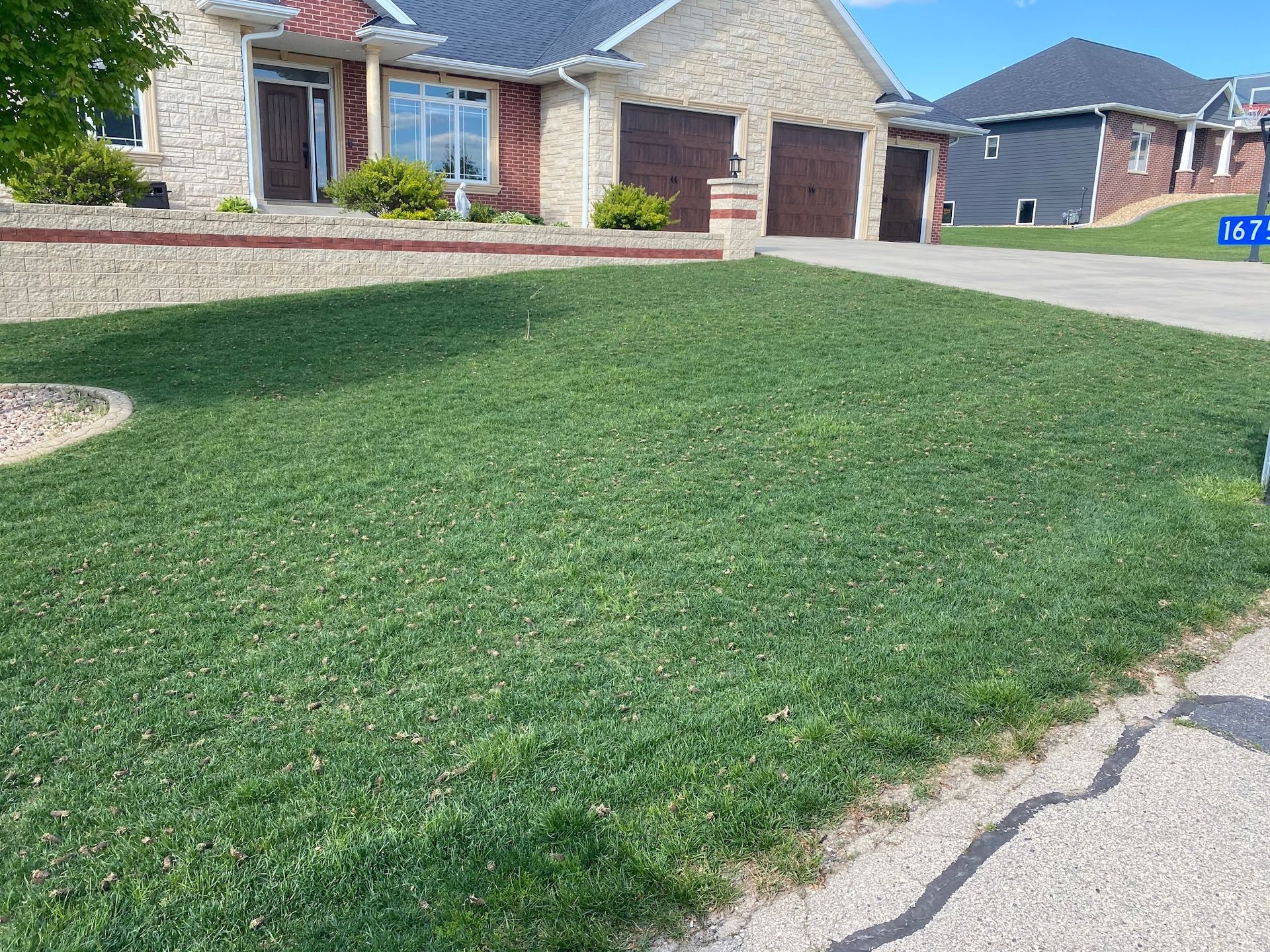 A house with a lush green lawn in front of it.