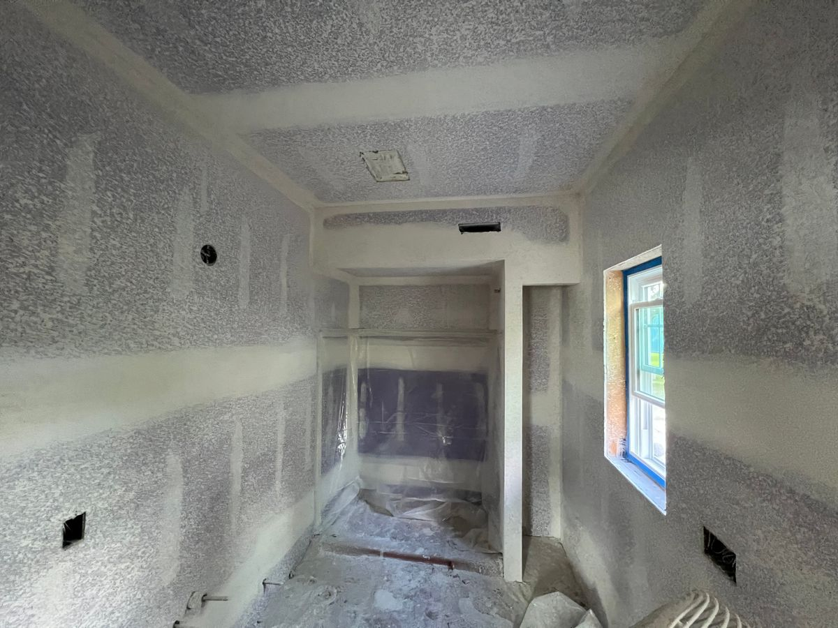 A room that is being remodeled with drywall and a window.