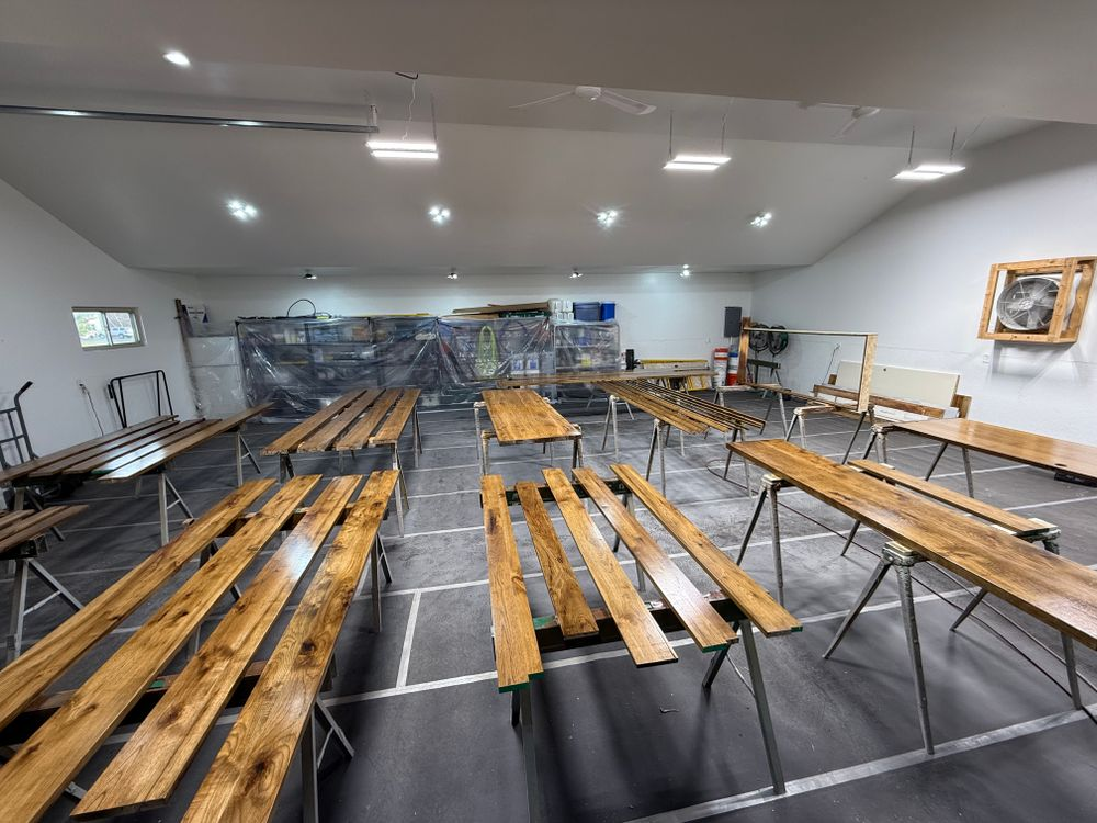 A room filled with wooden benches and tables.