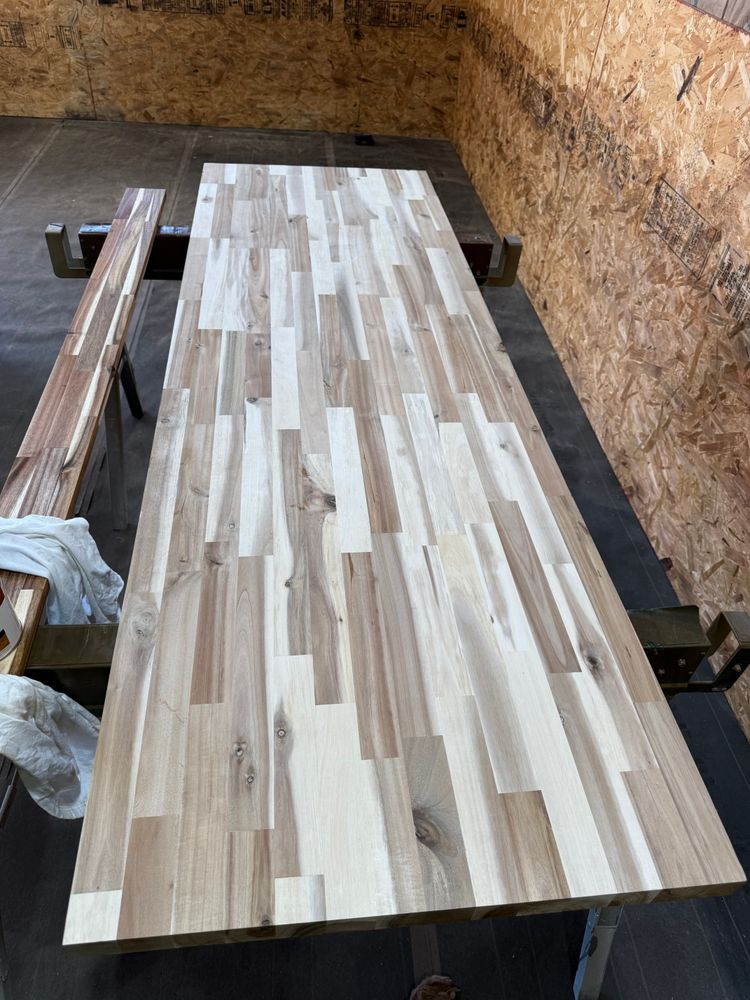 A wooden table with two benches sitting next to it in a room.