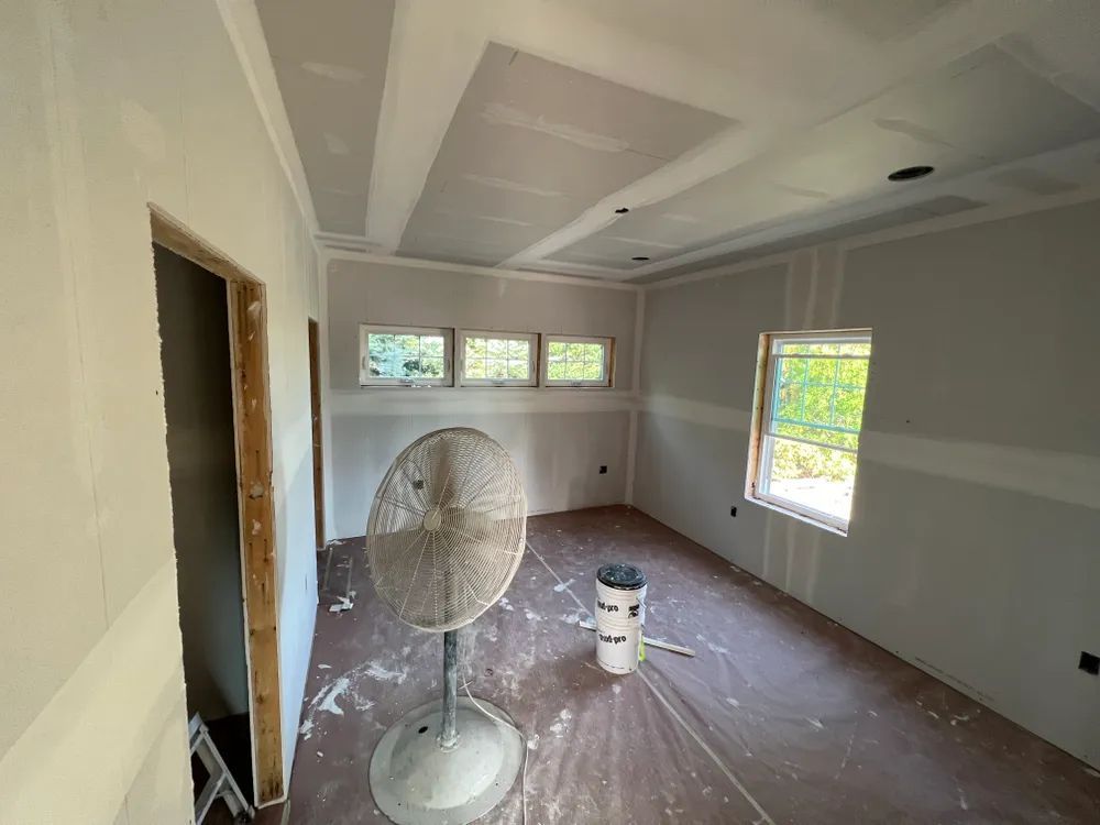 There is a fan in the middle of the room.