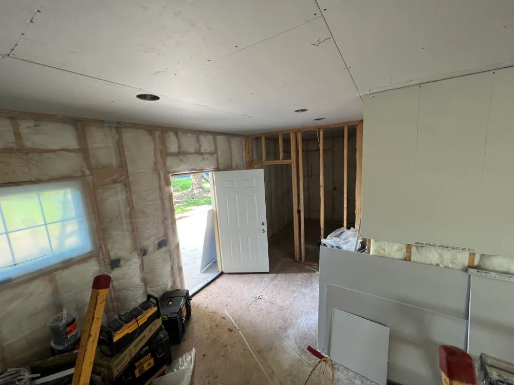 A room that is being remodeled with a door and a window.