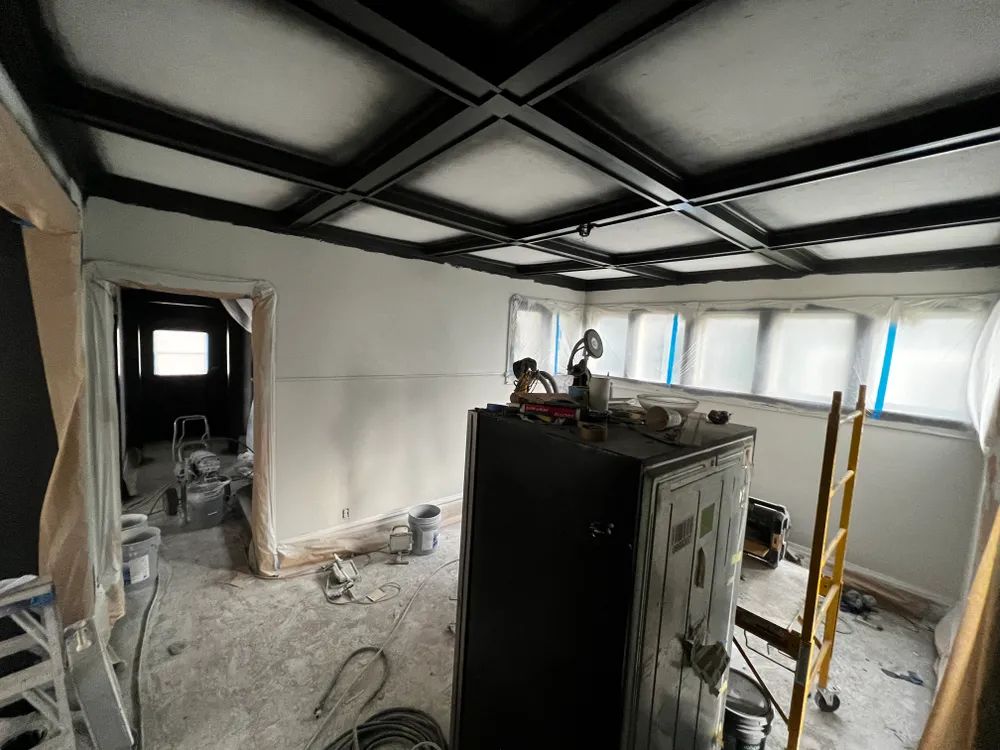 A room with a black ceiling and a safe in the middle of it.