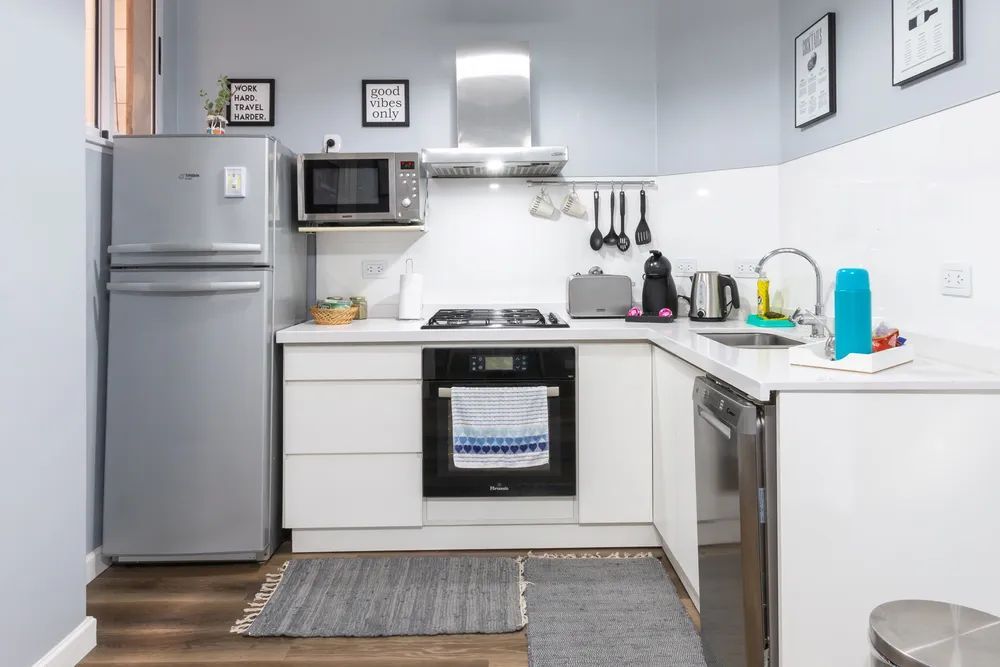 A kitchen with a refrigerator , stove , microwave , sink and dishwasher.
