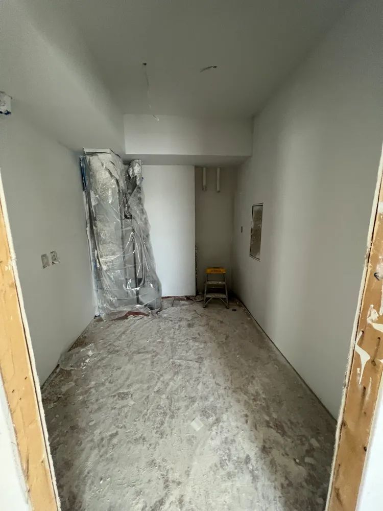 A room with a lot of dirt on the floor and walls.