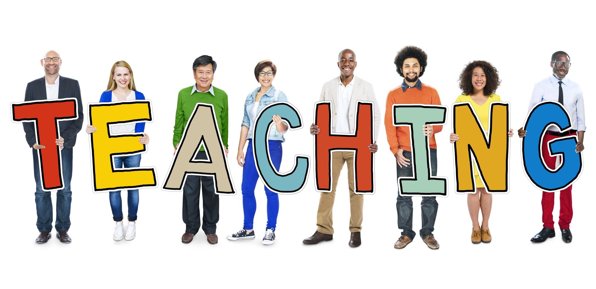 A group of people are holding up the word teaching.