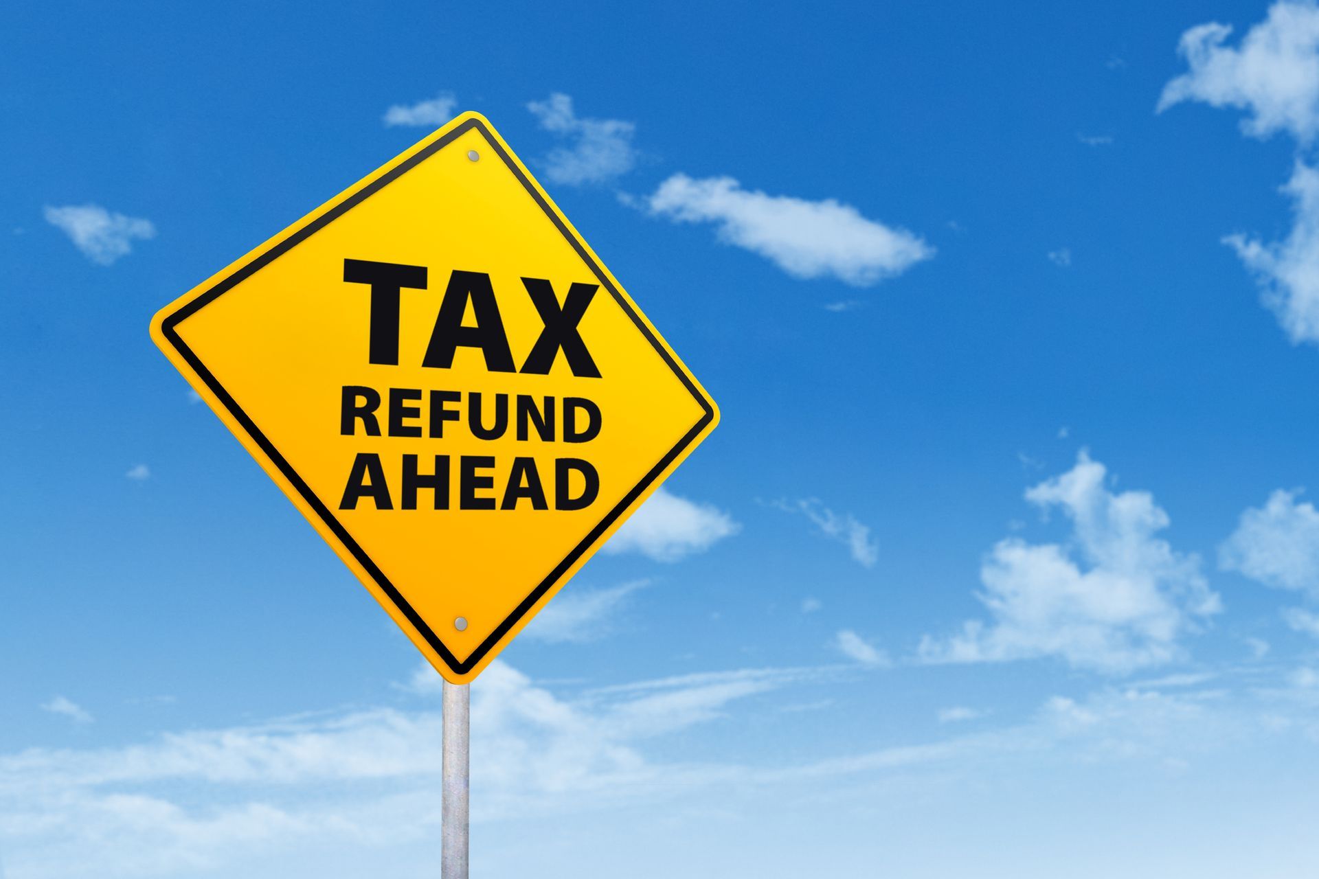 A yellow sign that says tax refund ahead