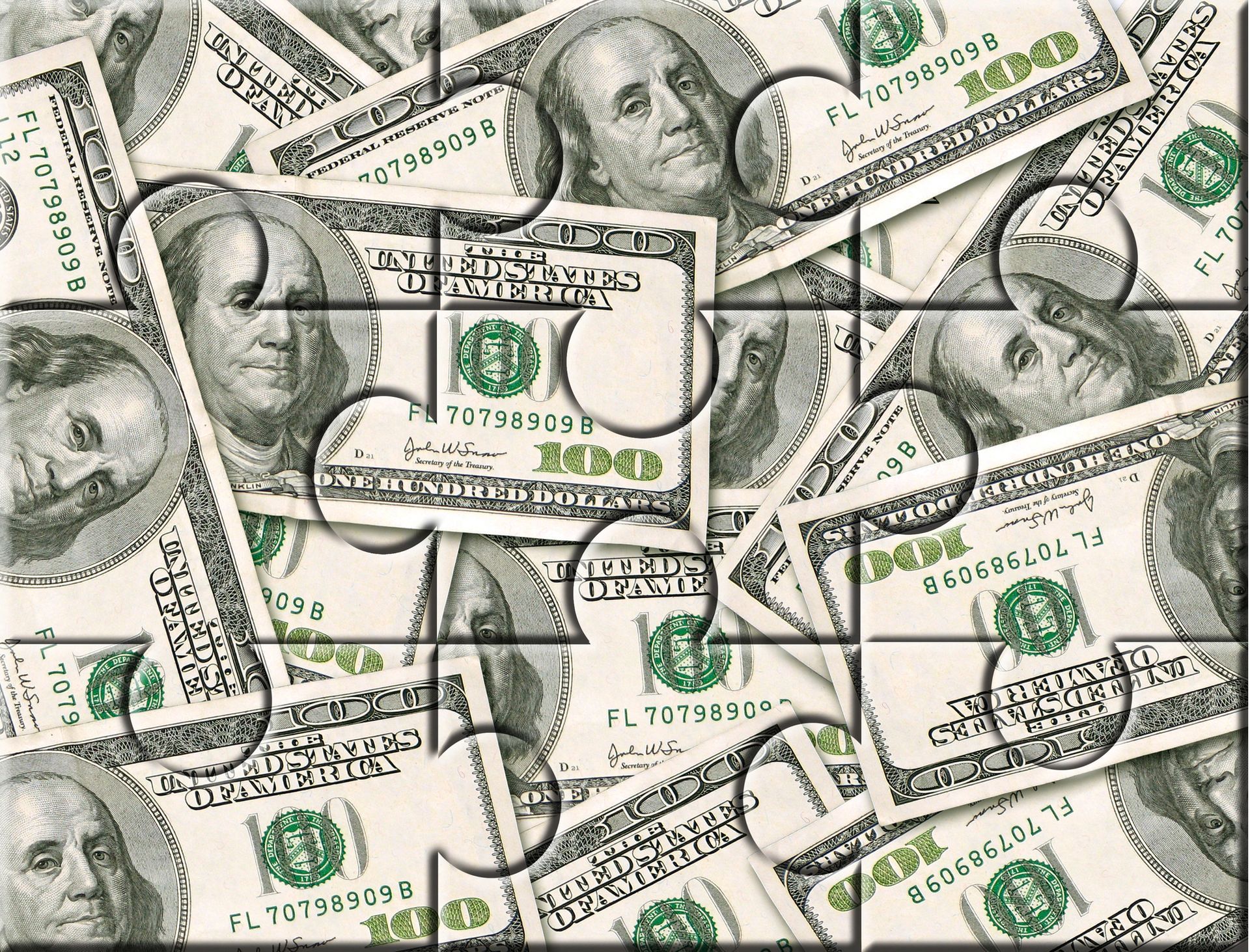 Puzzle of 100 dollar bills, scattered with a few pieces missing.