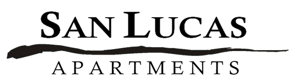 Logo for San Lucas Apartments, featuring bold serif text above a horizontal brushstroke and smaller sans-serif text.