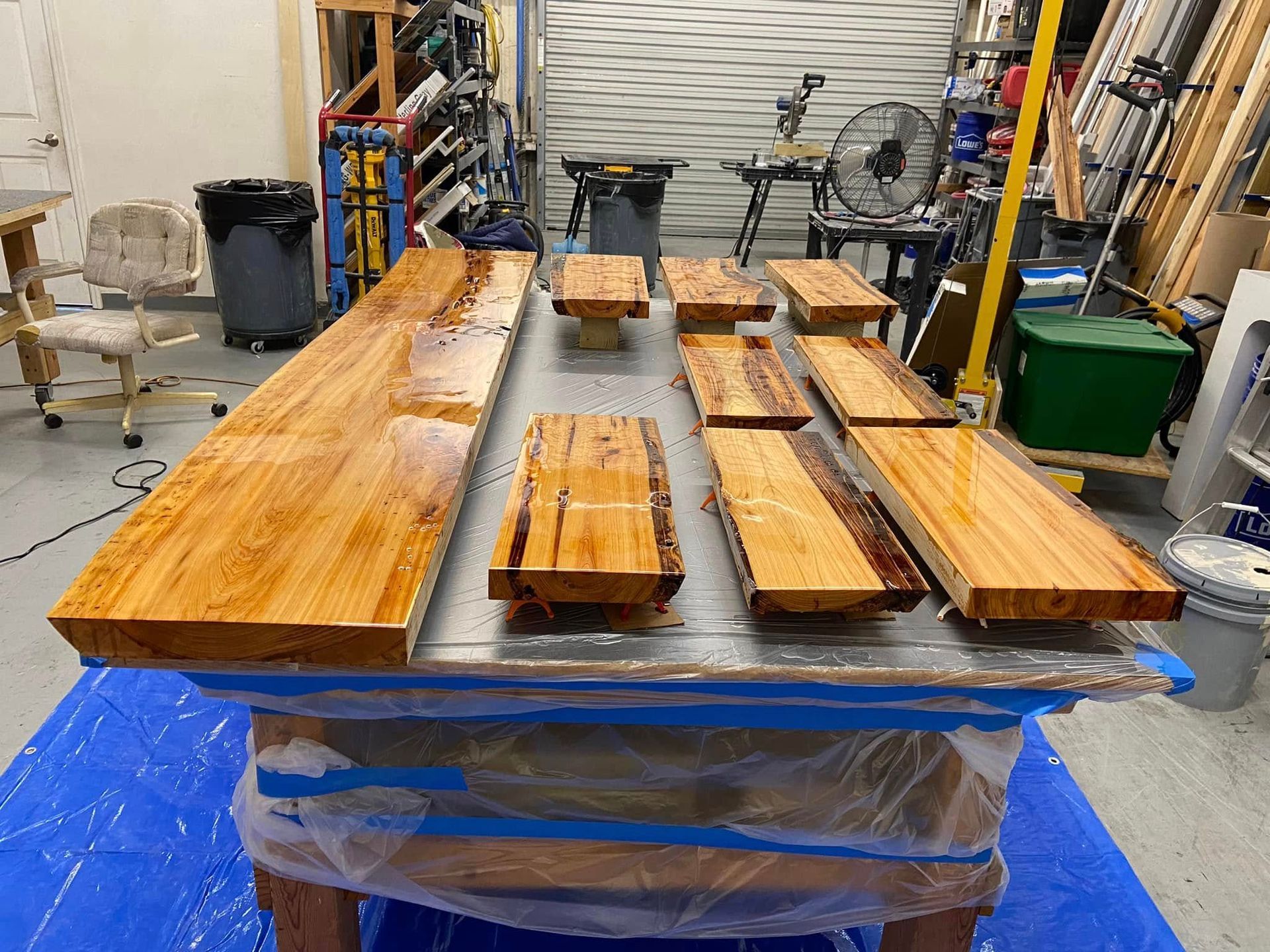 Wooden planks laid out on a worktable in a garage or workshop