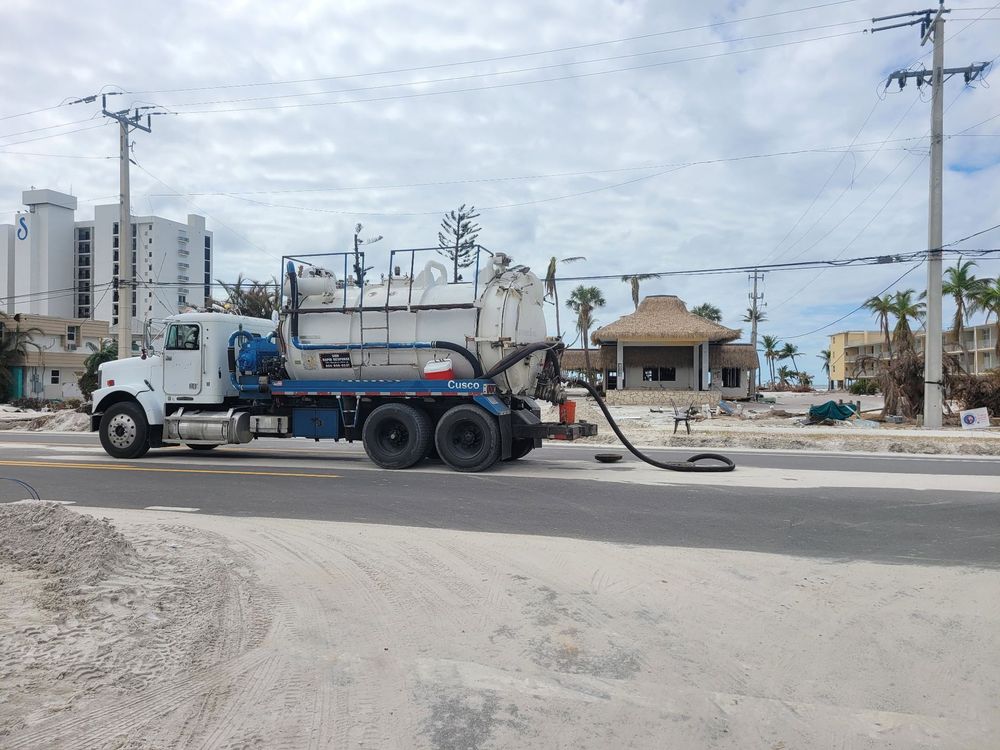 SMR Rapid Response vacuum truck with suction hose deployed on a city street