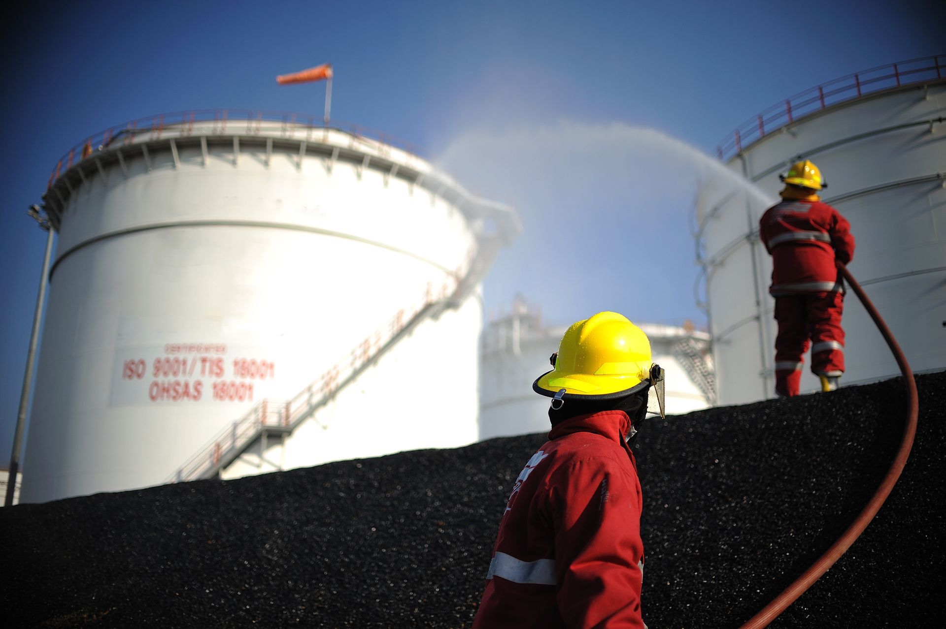 Practice fireman extinguishes oil spill. Practice fireman extinguishes oil spill.